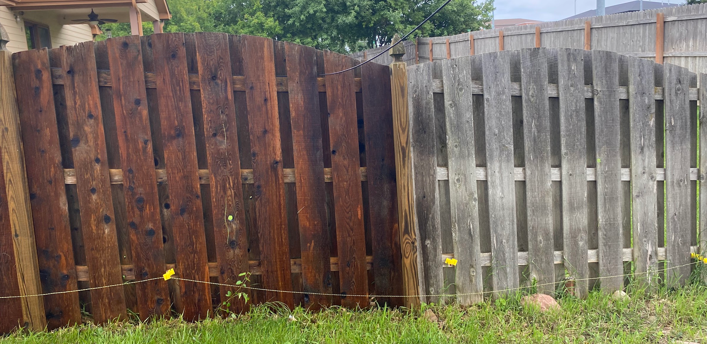 A Fence Showing Before And After Cleaning